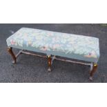 An upholstered stool bench/stool, the tapestry covered top with floral decoration, raised on oak