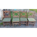 A set of four Antique oak dining chairs, with carved backs, upholstered seats, with carved front