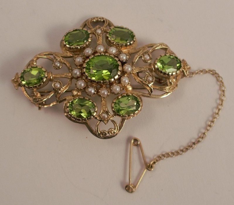 A peridot and cultured pearl Victorian style brooch, set with seven oval cuts, 4.9cm across, 11.7g