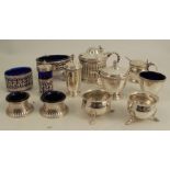 A collection of condiment pots, to include a Georgian silver oval open salt, two pairs of salts