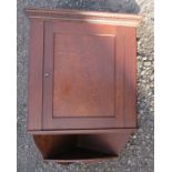 An oak corner cupboard, with dentil cornice over the single panel door, fitted with a shelf below,