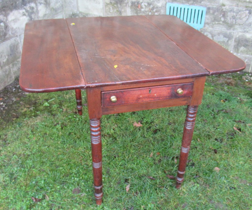 A 19th century mahogany Pembroke table, with drop flaps, with one real and one dummy drawers, raised