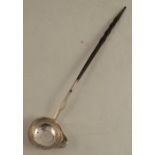 An Antique silver toddy ladle, the bowl set with a Georgian coin dated 1723, with twist