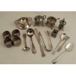 A hallmarked silver three piece cruet set, together with a hallmarked silver tea trainer and