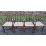 A set of four mahogany dining chairs, with carved swag decoration to the backs, having tapestry drop