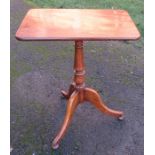 A 19th century mahogany rectangular topped tripod table, with tilt top raised on a turned column