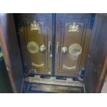 A Phillips & Son Two Door Safe in an oak case with painted faux book glazed doors (key missing)