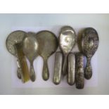 A Five Piece Silver Backed Hand Mirror and Brush Set, one other hand mirror, two other brushes and a