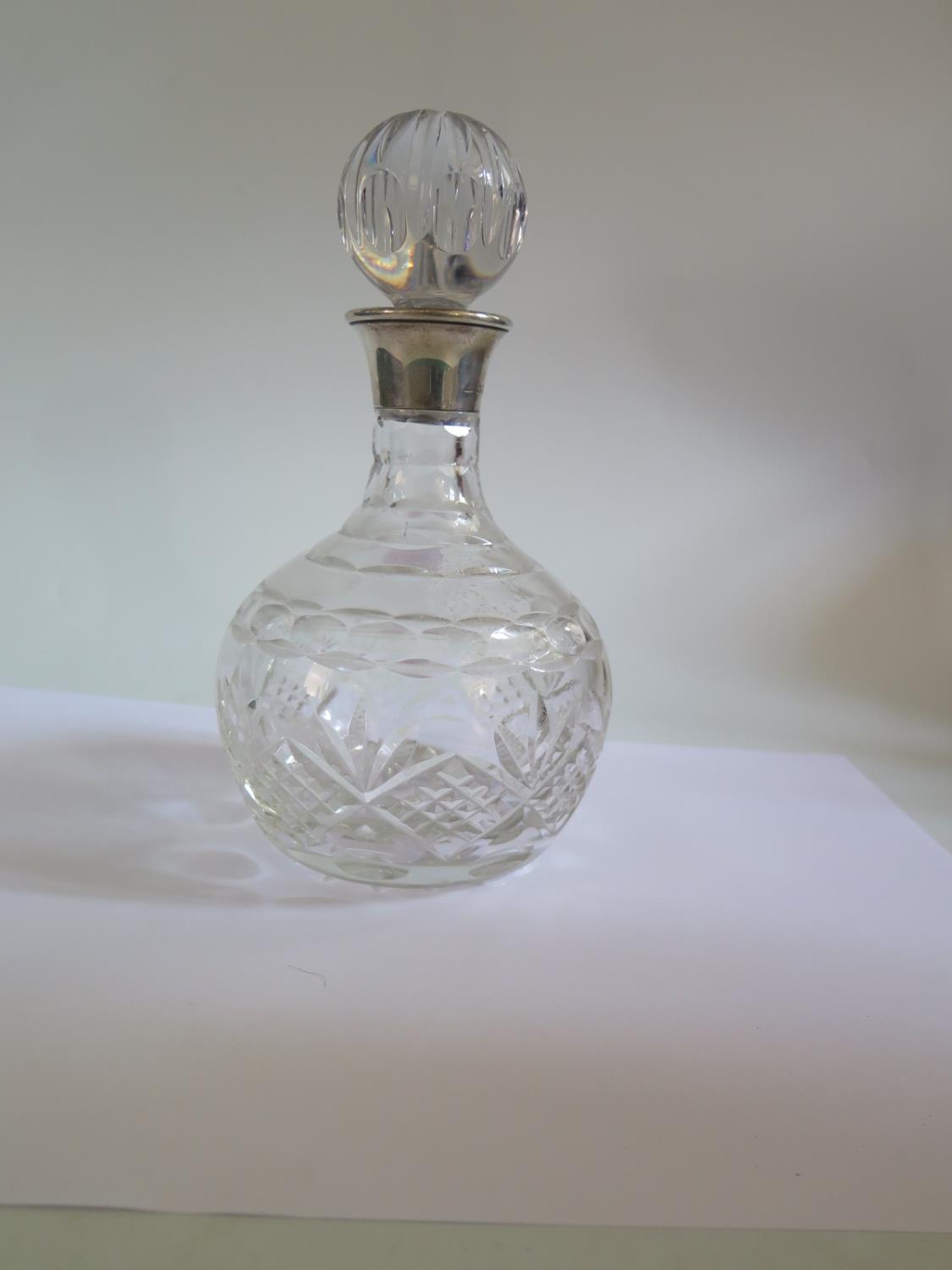 A Modern London Silver Top Cut Crystal Decanter, silver backed hand mirror and two brushes