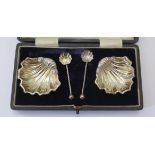 A Cased Pair of George V Silver Scallop Shell Salts with matching spoons, Chester 1912, James Deakin