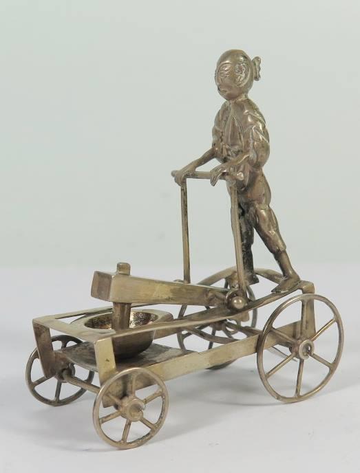A Hong Kong Silver Miniature of an Articulated Four Wheel Cart with bowl and crushing mechanism