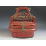 A 19th Century Chinese Wooden Basket with a carved, pierced and gilt decorated swing handle, 30cm