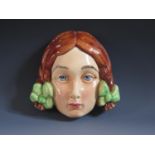 A Beswick Facial Wall Plaque, back stamped 393, crazing