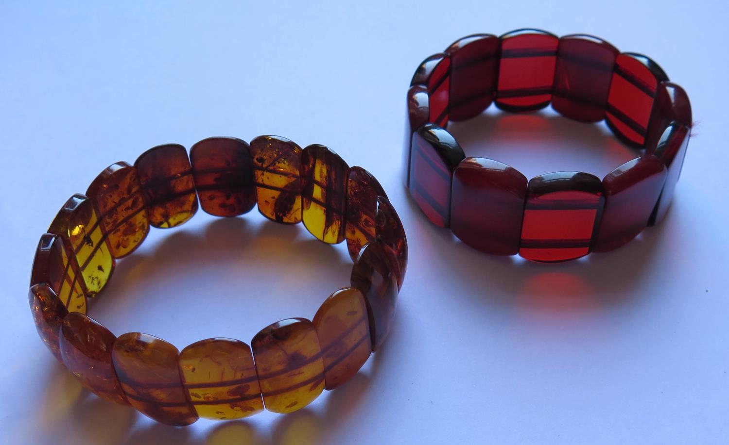 A Natural Orange Amber Bracelet with inclusions 20.7g and faux cherry amber bracelet 24.3g