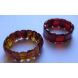 A Natural Orange Amber Bracelet with inclusions 20.7g and faux cherry amber bracelet 24.3g