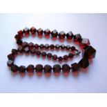A Graduated Faceted Faux Cherry Amber Bead Necklace, 61cm, 70.6g