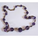 A Victorian Graduated and Faceted Amethyst Bead and Gold Necklace (unmarked), 43cm