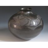 A Mata Ortiz Pottery Vessel, black on black pottery olla with traditional matte finish decorated