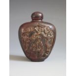 An 18th/19th Century Chinese Carved Rhoncerous Horn Snuff Bottle decorated with figures and foliage,