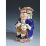 A Nineteenth Century Prattware Toby Jug, 26cm, replacement cup glued to hand, crazing