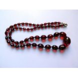 A Graduated Faceted Faux Cherry Amber Bead Necklace, 67cm, 32.1g