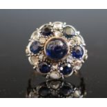 An Antique Cabochon and Round Cut Sapphire and Rose Cut Diamond Dress Ring in a foliate high carat