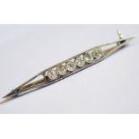 A Diamond Six Stone Bar Brooch in a precious white metal mount (unmarked), 5cm, 5.1g EDW .7ct