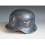 A WWII German Luftwaffe DD helmet with early Eagle transfer, rim stamped Q62 & T605, with chin strap