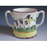 A Nineteenth Century Loving Cup with frog inside and decorated with relief scenes of pointer and