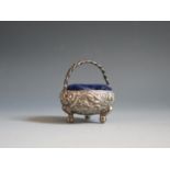 An Indian Silver Miniature Basket Pin Cushion decorated with animals and a building in a jungle,
