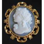 An Hardstone Cameo Brooch decorated with a female bust and in a high carat precious yellow metal