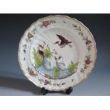 A Herend Porcelain Plate decorated with swans and herons painted in enamels with light relief,