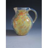 Richard Wilson Studio Pottery Jug with a patterned slipware glaze, impressed mark below handle, 16.