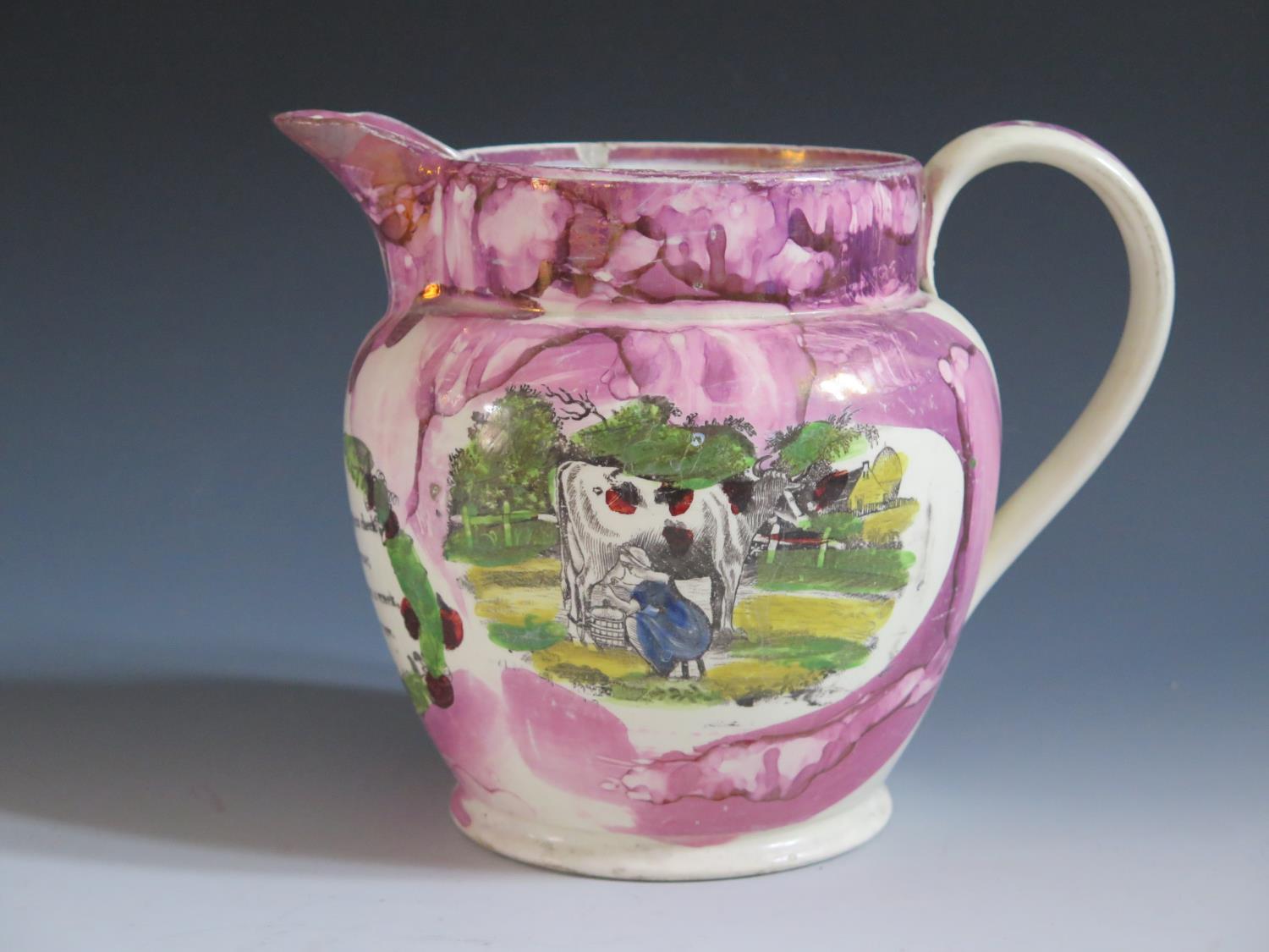 A Sunderland Lustre Jug decorated in polychrome with a made milking a cow, The Iron Bridge and