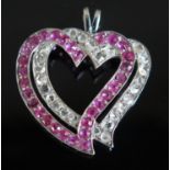 A Victorian Ruby and Diamond Witches Heart Pendant in an unmarked precious white metal mount,