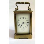 A Metcalf & Co. Brass Carriage Clock with balance wheel to the back, 13cm to top of handle, running