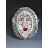 A Cleo Mussi (b.1965) Ceramic Mosaic 'Platter Face 3, the oval face made from a mosaic of domestic