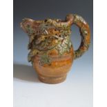 A Mid 19th Century Sussex Rye Pottery Puzzle Jug with treacle glaze and green glazed applied hop