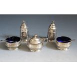 A George V Silver Five Part Cruet Set with blue glass liners (and three matched spoons), Chester