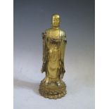 A Sino Tibetan Gilt Bronze Buddha standing on lotus blossom, leaf mark to base, 23.5cm