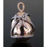An 18ct Rose Gold and Diamond Ribbon Inlaid Egg Pendant, 3cm long, 14.3g
