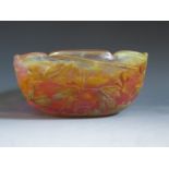 A Daum Nancy Cameo Glass Bowl decorated with flowers in greens, orange brown, pink and yellow