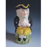 A Nineteenth Century Staffordshire Toby Jug, 13.5cm, rim damaged and crazing