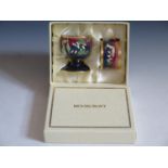A Modern Moorcroft Enamel Egg Cup and Napkin Ring Boxed Set decorated with berries, dated 03