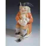 A Nineteenth Century Toby Jug, 26cm, loss and repair to rim, hand and handle glued, crazing