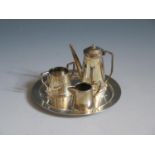 An Elizabeth II Silver Dolls House Miniature Four Part Coffee Set including a circular tray,