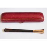 A 9ct Gold Mounted and Tortoiseshell Cigarette Holder in a gilt Morocco case, 10cm long