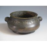 A Chinese Bronze Censer with bird and bat border and mask handles, four character mark to base, 14.