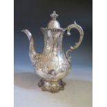 A Victorian Silver Coffee Pot with embossed foliate decoration, London 1851, Edward and John