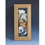 A Modern Moorcroft Miss Alice Pattern Plaque dated 2005 and framed by The Art Studio, 40x19cm